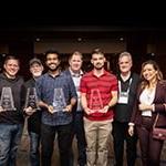The recipients of the Made with Unity recognition award stand with their statuettes with Full Sail and Advent Health University course and education directors.